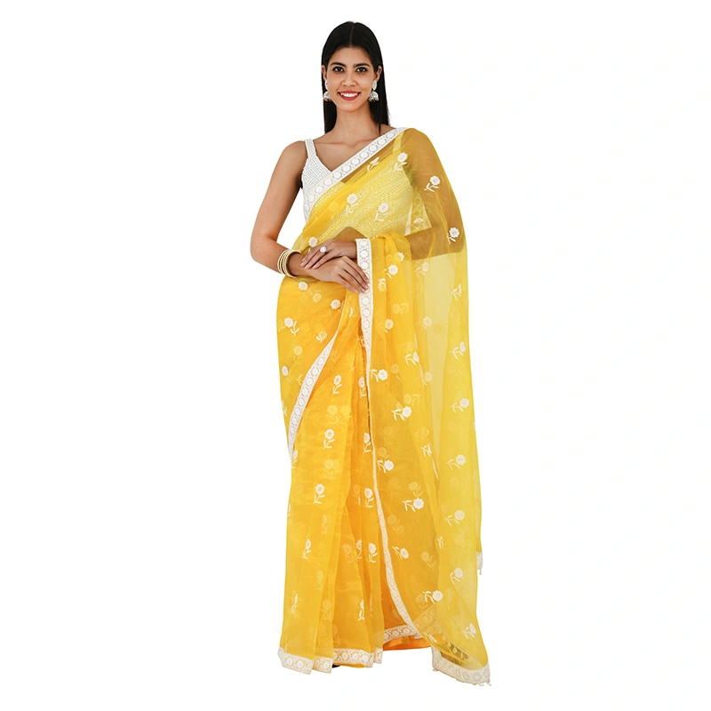 Female model in yellow organza saree with white floral embroidery and embellished blouse - ethnic wear ecommerce photography by Lohar Studio Delhi